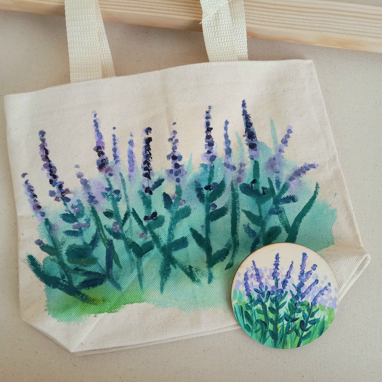 Canvas bag with lavender floral imagery painted on.
